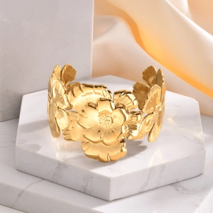 Exaggerated golden stainless steel open cuff bracelet with detailed floral engravings