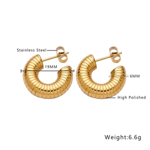Macro view of 19mm gold-plated stainless steel hoop earrings with ribbed texture detail