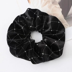 Black velvet scrunchie with silver polka dot grid pattern on a clean white background
