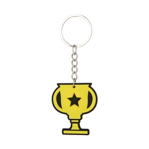 Close-up of yellow trophy PVC keychain with black star pattern for sports parties