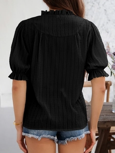 Back view of black textured blouse with bell sleeves and ruffle trim detailing