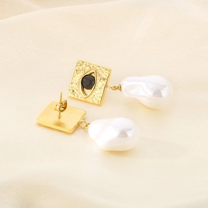 Detail of evil eye square studs with hanging white baroque pearls on silk
