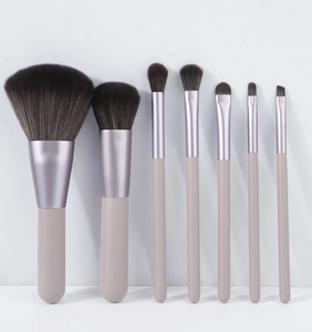 Detailed set of seven professional makeup brushes with soft bristles and purple handles