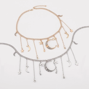 Detail of star and moon tassels on gold and silver chain belts with rhinestone charms