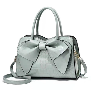 Mint green bow handbag with crocodile pattern and detachable shoulder strap