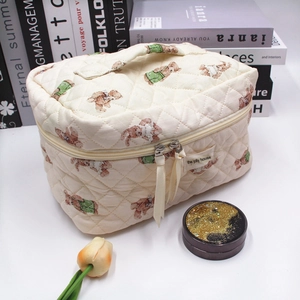 Quilted beige cosmetic bag with teddy bear print and convenient top handle
