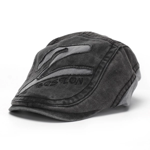 Detailed macro view of vintage washed denim men's flat cap with BOSTON embroidery