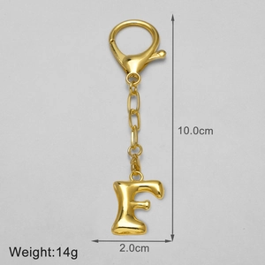 Macro view of polished 18k gold plated letter F keychain pendant with size dimensions