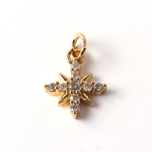 Detailed close-up of gold-plated cross star pendant set with clear cubic zirconia stones