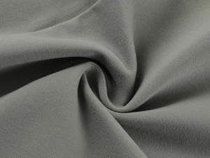 Close-up of the grey-olive breathable knit fabric texture with soft elastic folds