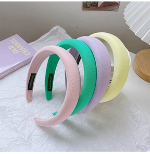 Detailed close-up of handmade padded sponge headbands in soft pastel macaron colors