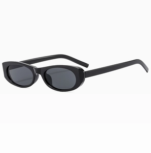 Side view of black oval sunglasses featuring a slim frame and dark UV protective lenses