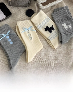 Close-up of cotton socks with silk bows and embroidered puppy patterns in Korean style