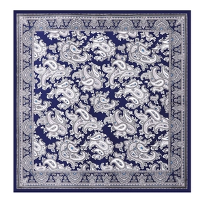 Flat lay detail showing classic dark blue paisley pattern on a square silk-like scarf