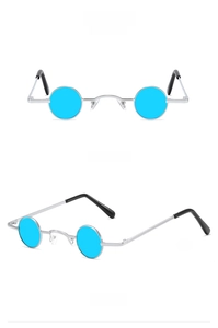 Detail view of small round punk sunglasses with silver metal frames and blue lenses