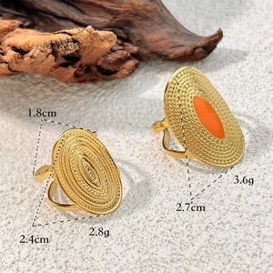 Minimalist gold stainless steel oval rings with relief texture and orange enamel inlay