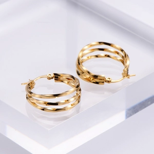 Polished golden twist hoop earrings with a multi-layered spiral design for women