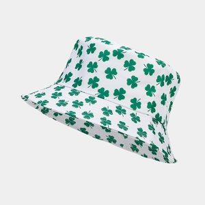 Detailed close-up of white bucket hat featuring green shamrock pattern and soft fabric texture