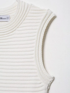 Detail of white knit top neckline showing premium ribbed texture and size label info
