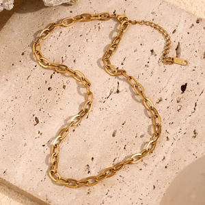 Minimalist 18K gold plated stainless steel O-chain necklace on a natural stone background