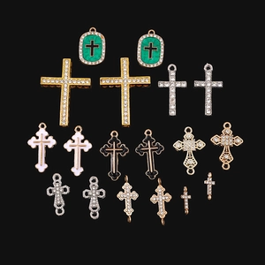 Variety of rhinestone cross pendants in gold, silver and enamel finishes on black background