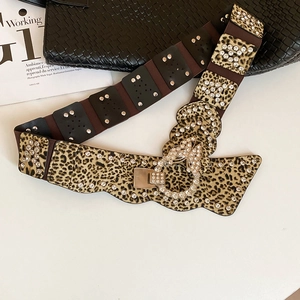 Detail of leopard print leather belt with sparkling rhinestones and metal buckle