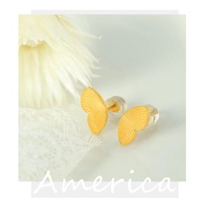 Macro shot of 18k gold plated butterfly wing earrings with fine embossed textures
