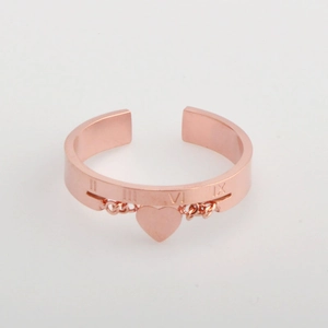 Rose gold heart pendant ring with Roman numeral engraving on a minimalist open band
