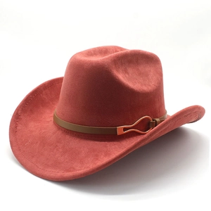 Detail of western cowboy hat with brown leather band and gold buckle on felt surface