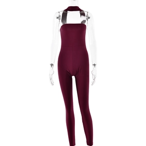 Detail of burgundy halter neck jumpsuit showing elastic fit and slim leg design