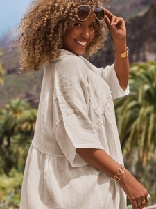 Close-up of linen-style polo collar loose dress with natural texture and buttons