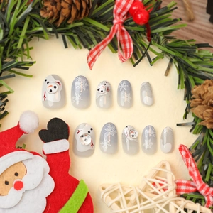 Handmade Christmas press-on nails featuring gray snowflake and 3D snowman designs
