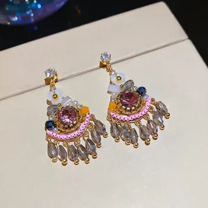 Bohemian fan-shaped drop earrings with pink stones and grey crystal beads in gold
