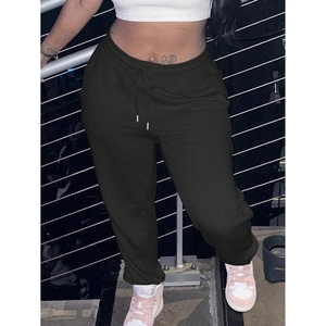 Detail of dark drawstring waist on loose sport sweatpants with metallic ladder background