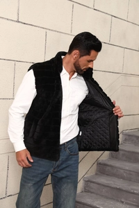 Detailed view of the quilted lining and premium faux fur texture of the black vest