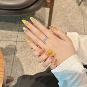 French style gold gradient press-on nails with 3D floral accents and rhinestones