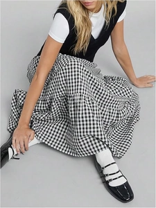 Detail of tiered plaid maxi skirt featuring black and white cotton fabric textures