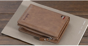 Close-up of brown leather wallet featuring embossed logo and colorful stripe detail