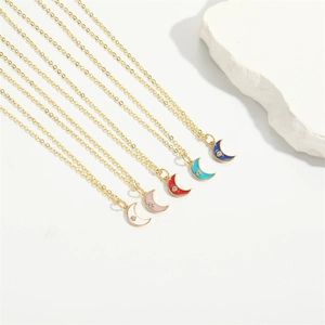 Detail showing five crescent moon pendants in vibrant enamel colors with crystal accents