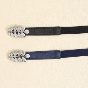 Detail view of elastic waist belts featuring silver leaf buckles in black and navy blue