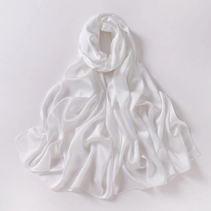 Close-up of white chiffon silk scarf showing smooth fabric texture and elegant pleats