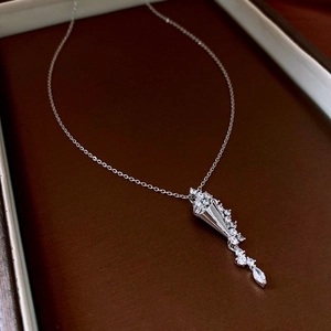 Close-up of hourglass teardrop necklace with zircon flower pendant in silver finish