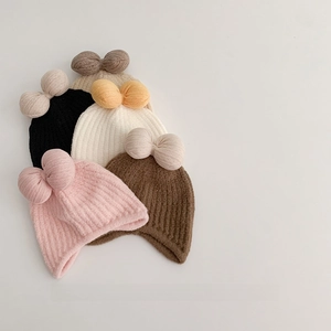 Knitted winter hats for baby girls with large bows in pink, beige, and neutral colors