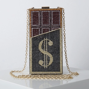 Macro shot of dollar sign crystal clutch with chocolate bar design and gold chain