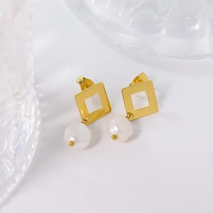 French baroque pearl earrings with golden square geometric studs on gray backdrop