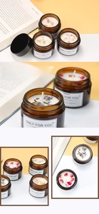 Macro shot of handmade soy candle in amber glass jar with dried flower petals decoration