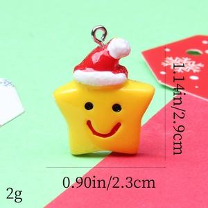 Macro shot of yellow resin star pendant with red Santa hat and dimensions shown