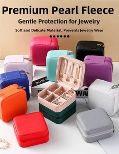 Close-up of colorful velvet jewelry boxes showing multiple necklace hooks and ring slots