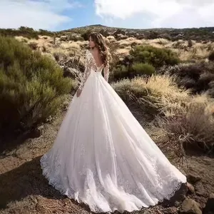 Elegant long sleeve lace wedding dress with deep V back and long trailing skirt