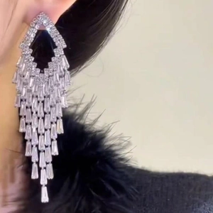 Elegant silver rhombic tassel earrings with sparkling zircon crystals on model